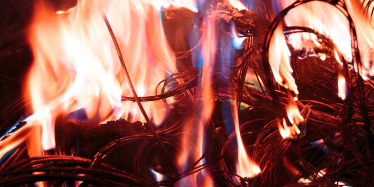 wires on fire. Firing winding insulation of electrical wiring in the fire close-up